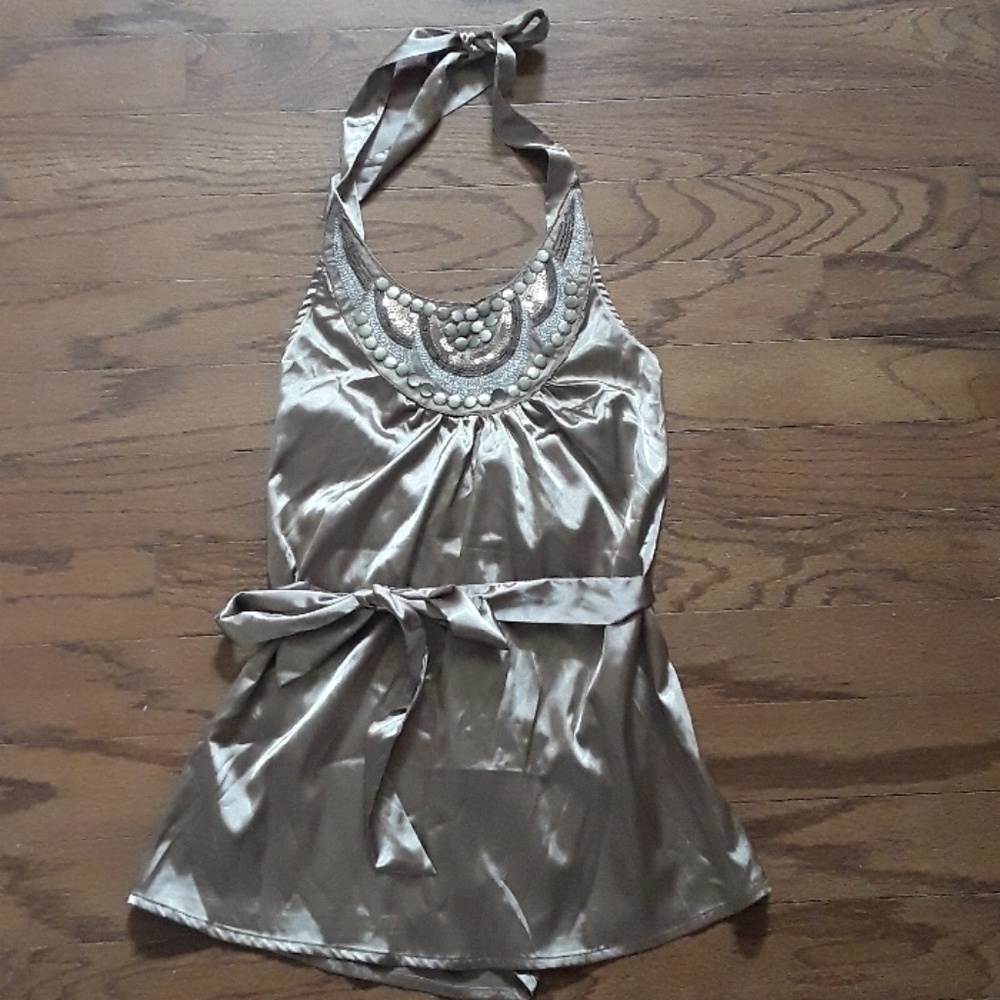 Neverworn silk halter top ties around the waist.